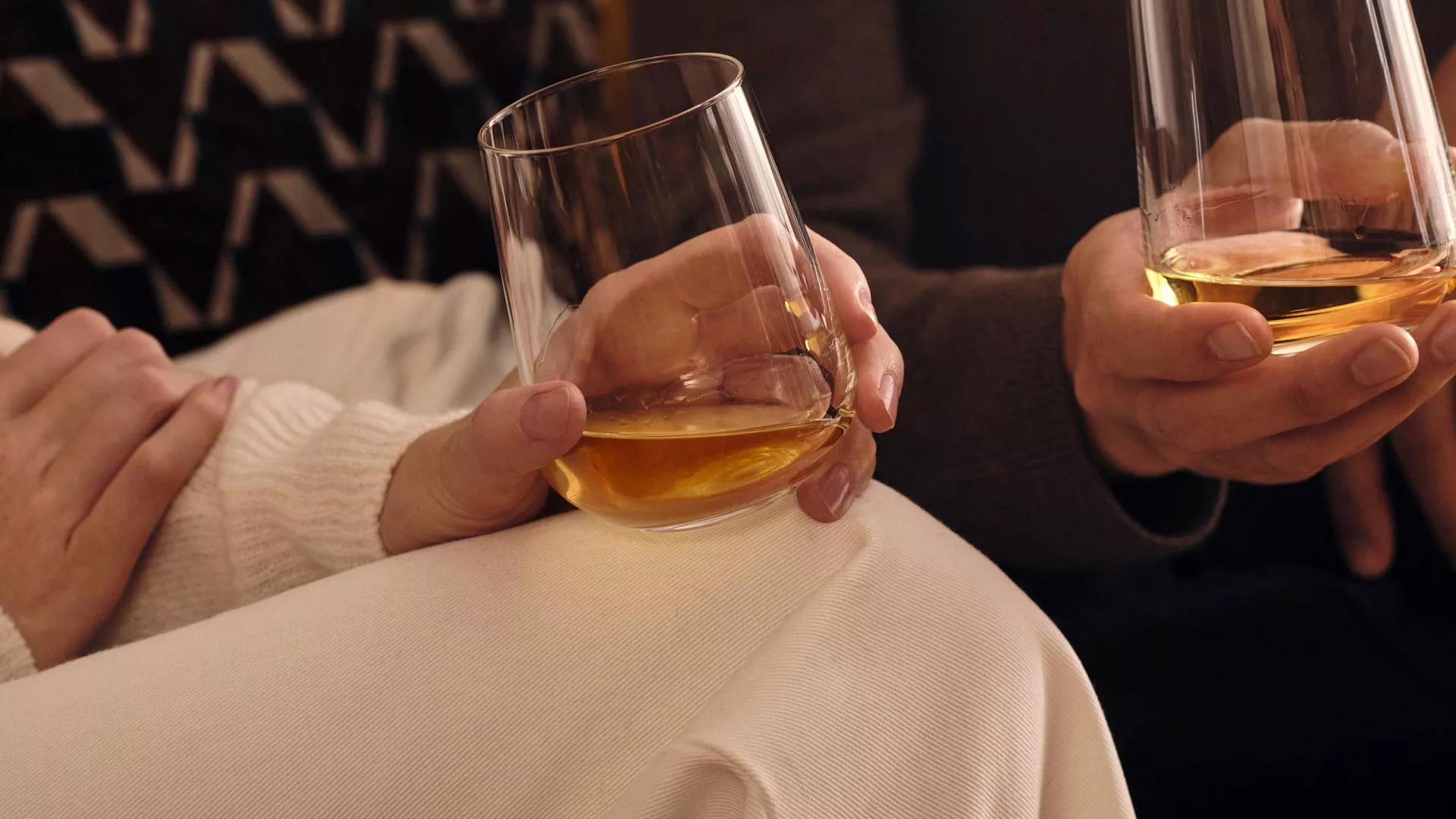 two people holding glasses of Ardray blended scotch whisky